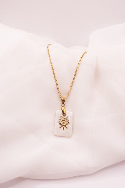 Petit Collier Solis en porcelaine artisanale avec motif soleil doré. Bijou fait main dans le Sud de la France, délicat et lumineux.